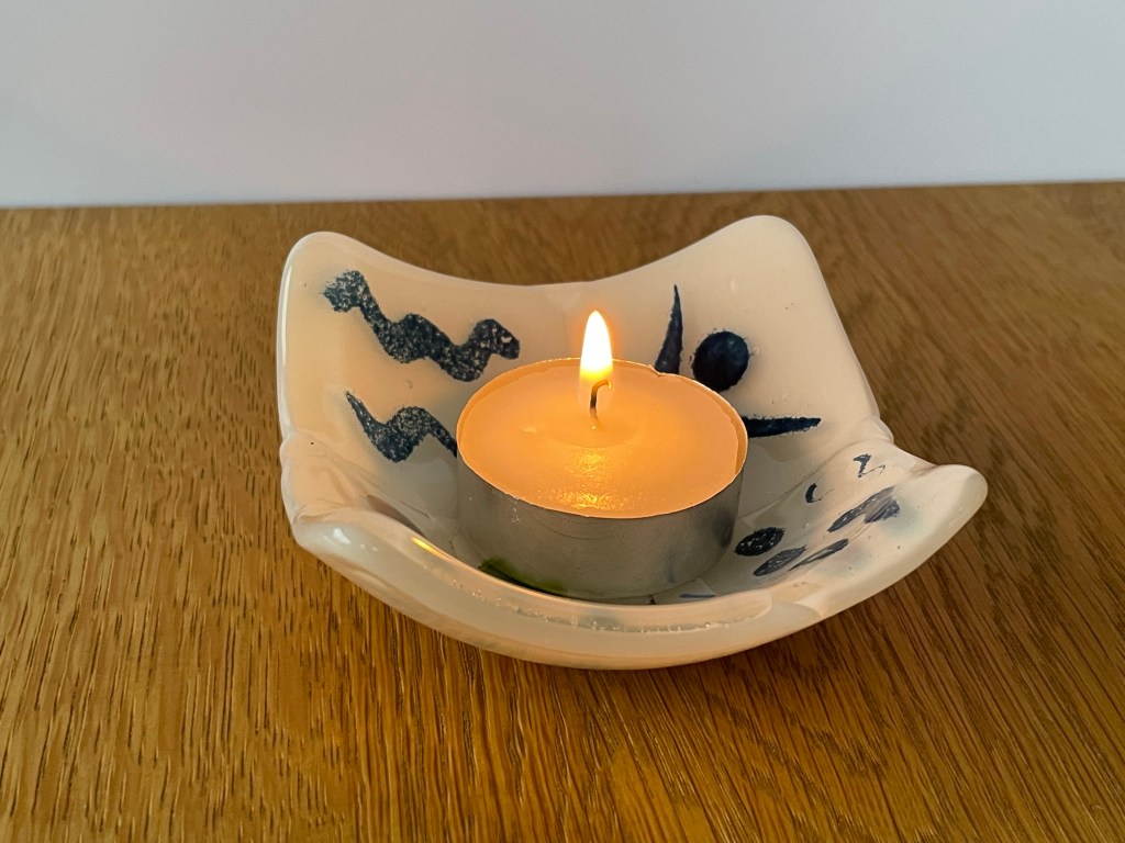 Tea light holder made from scrap glass