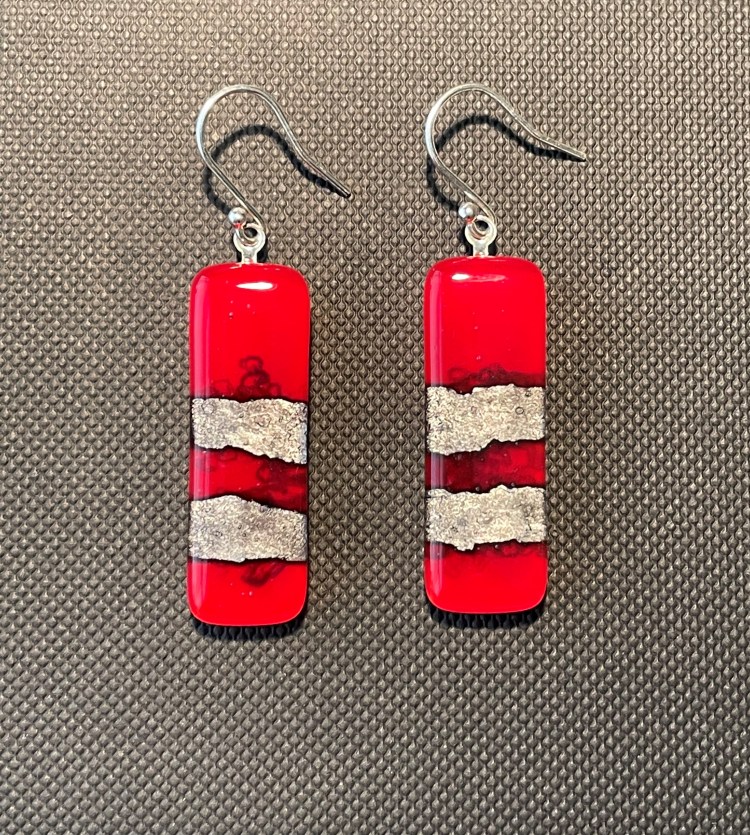 Red earrings with silver foil embedded.