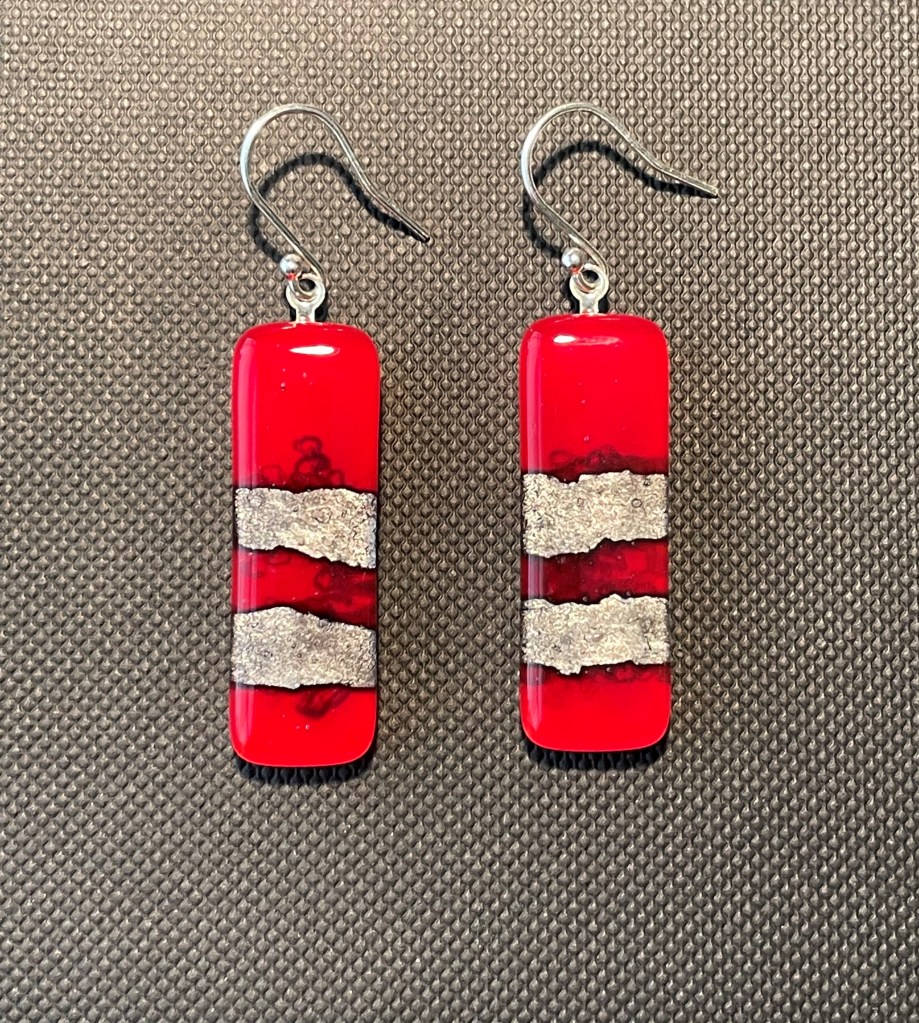 Red earrings with silver foil embedded.