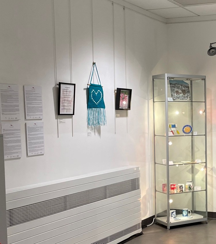 View of part of exhibition, including display cabinet