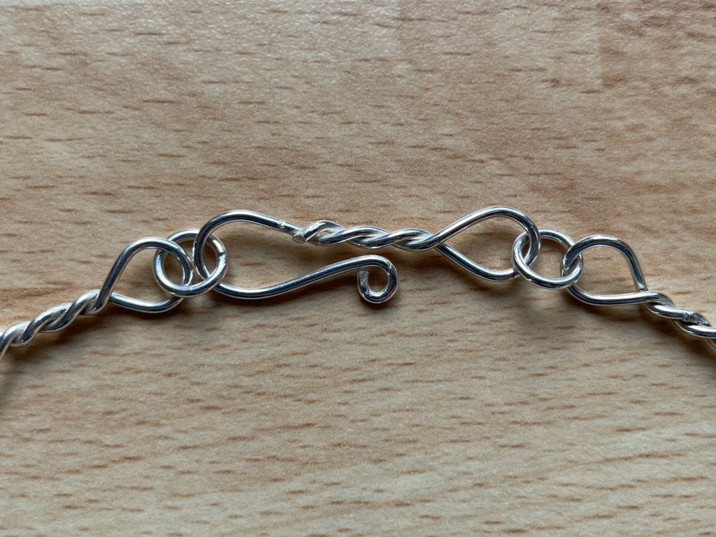 Close up of clasp made from silver wire.