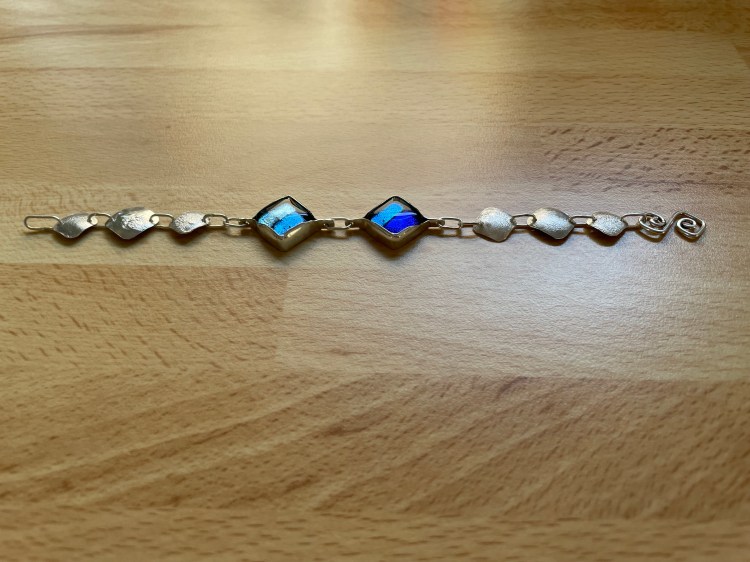 Bracelet using fused glass cabochons set in sterling silver bezels and using reticulation on sheet silver.