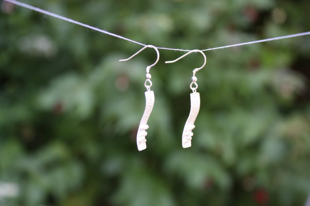 Side view of earrings showing curvature applied.