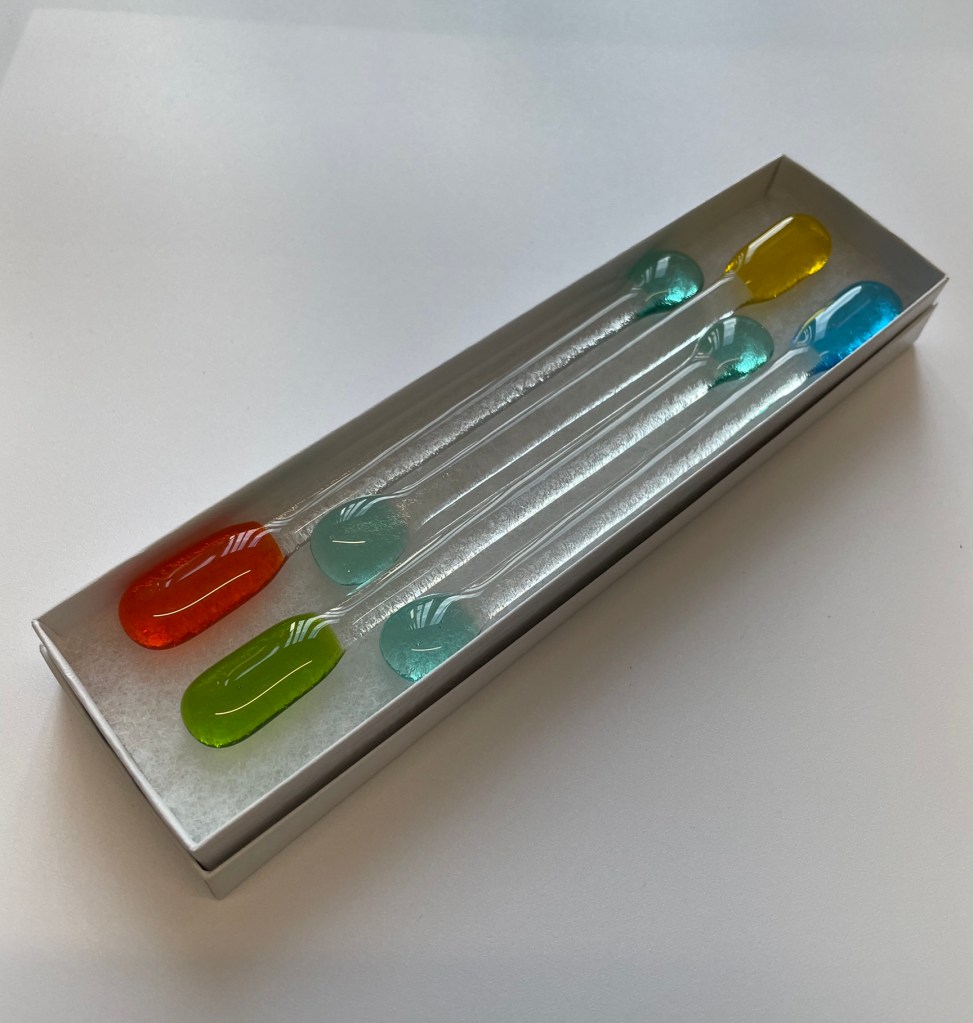 Swizzle sticks - green, orange, blue and yellow - in a gift box