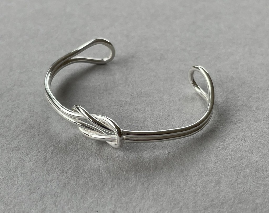 A reef knot bangle in sterling silver