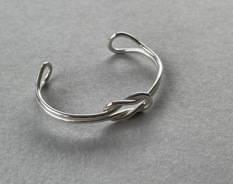 A reef knot bangle in sterling silver
