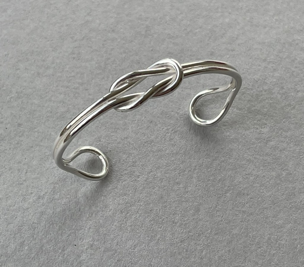 A reef knot bangle in sterling silver