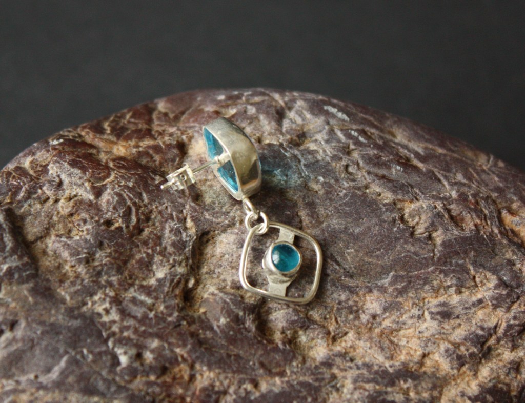 Ear stud part of asymmetric earrings set.