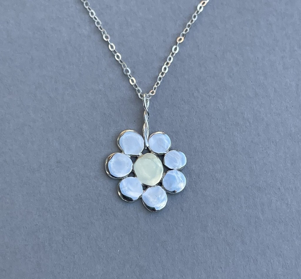 Flower pendant made from scrap silver and brass.